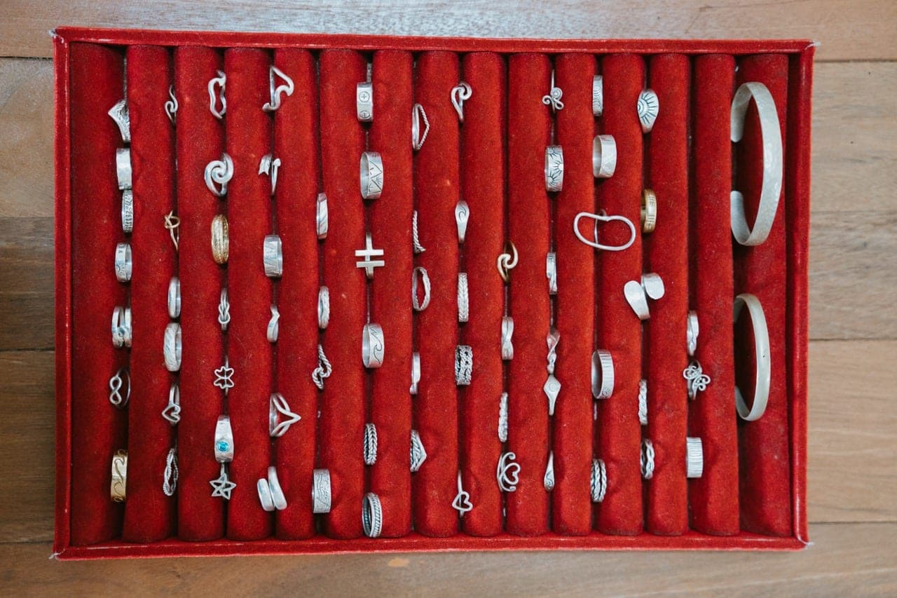 A tray of handmade silver ring designs to choose from at a group silver class in Kuta